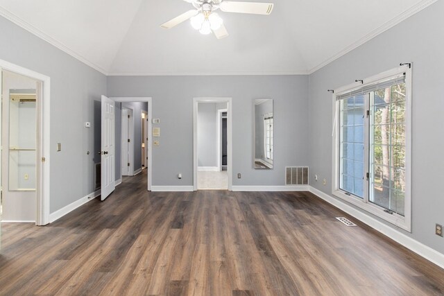 unfurnished bedroom featuring dark hardwood / wood-style floors, ceiling fan, crown molding, and vaulted ceiling