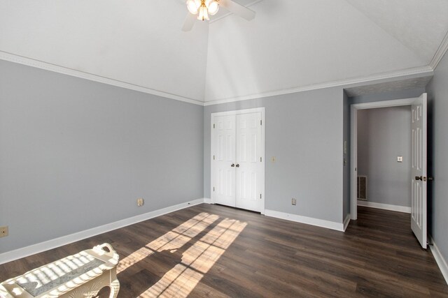 unfurnished bedroom with vaulted ceiling, ceiling fan, and dark wood-type flooring