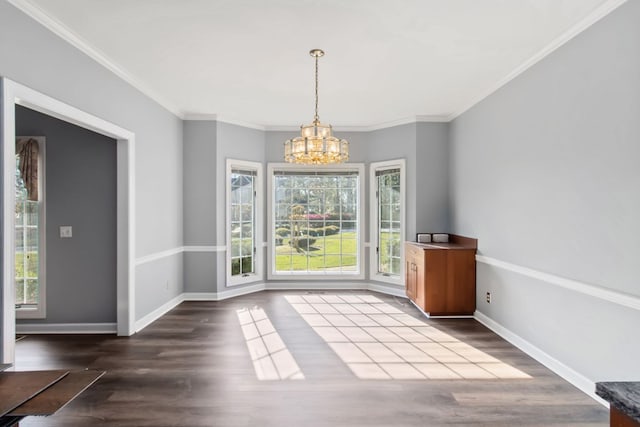 unfurnished dining area featuring a chandelier, dark hardwood / wood-style floors, and crown molding