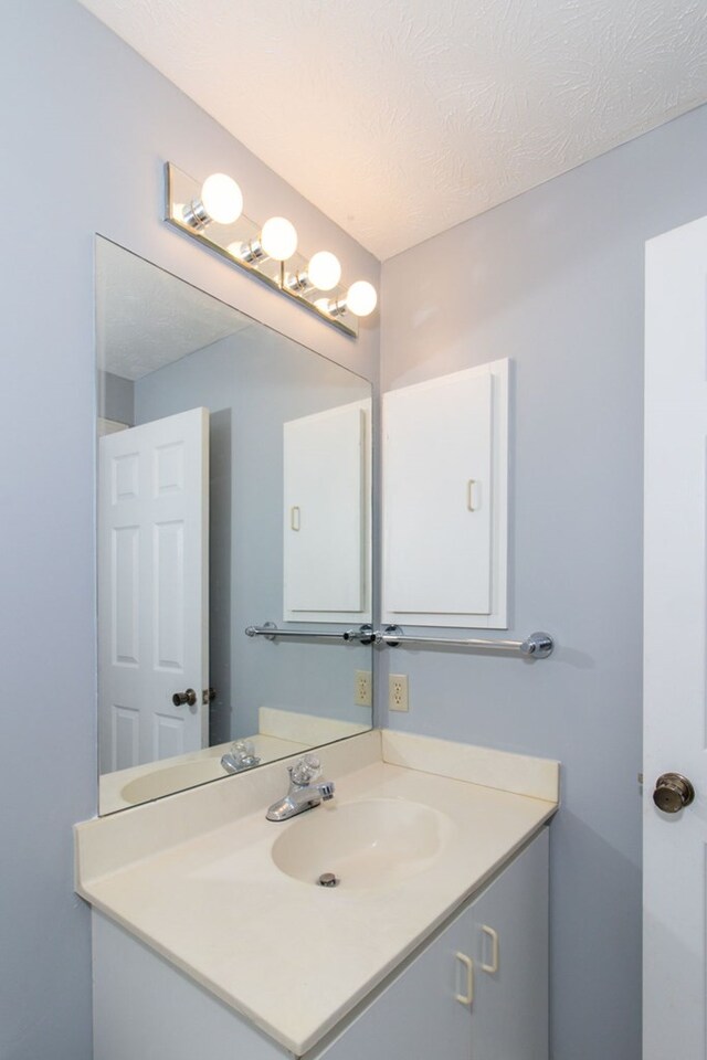 bathroom featuring vanity and a textured ceiling