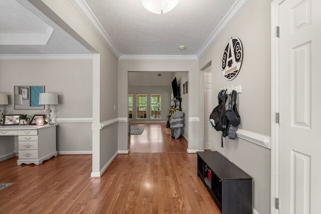 485 Boyd Branch Dr, Upatoi, GA 31829 - foyer with wood finished floors, a textured ceiling, baseboards, and crown molding