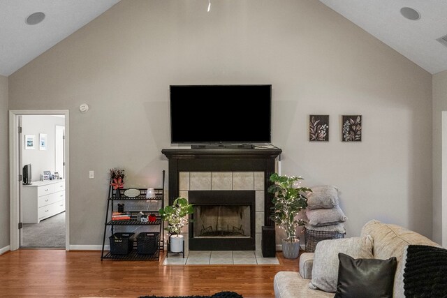 485 Boyd Branch Dr, Upatoi, GA 31829 - living room with high vaulted ceiling, a tiled fireplace, wood finished floors, and baseboards