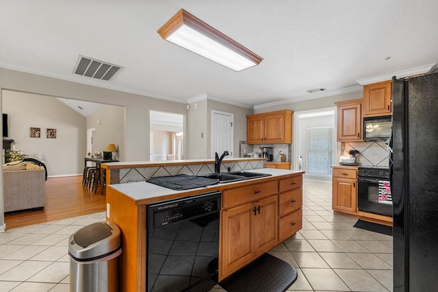 485 Boyd Branch Dr, Upatoi, GA 31829 - kitchen with black appliances, a sink, open floor plan, an island with sink, and decorative backsplash