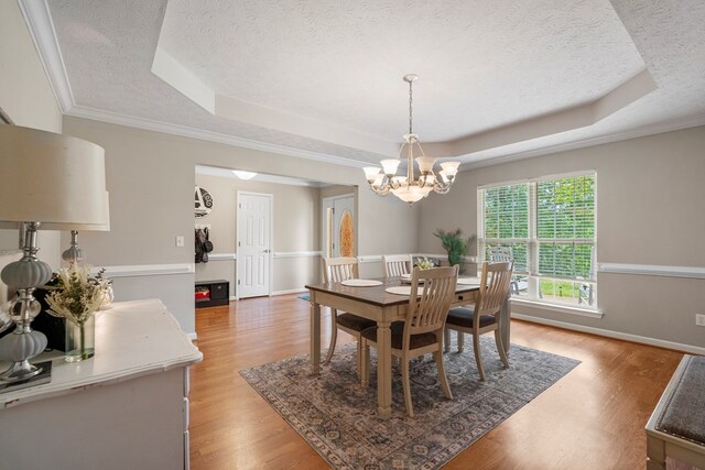 485 Boyd Branch Dr, Upatoi, GA 31829 - dining area featuring a raised ceiling, a textured ceiling, light wood finished floors, a chandelier, and baseboards