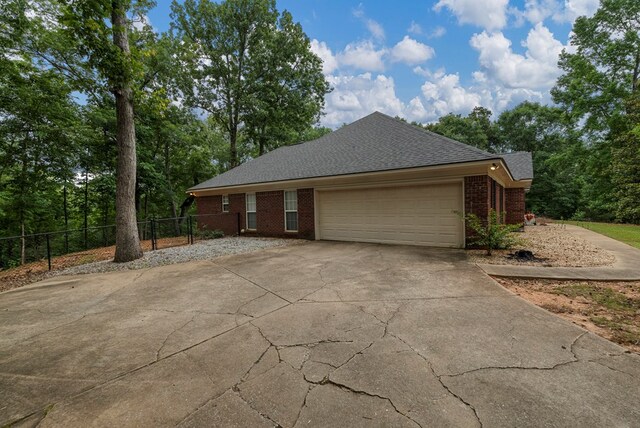 485 Boyd Branch Dr, Upatoi, GA 31829 - view of side of property with concrete driveway, brick siding, an attached garage, and roof with shingles