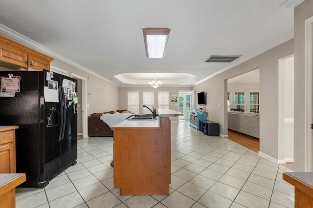 485 Boyd Branch Dr, Upatoi, GA 31829 - kitchen with black fridge, open floor plan, a sink, light tile patterned flooring, and ornamental molding