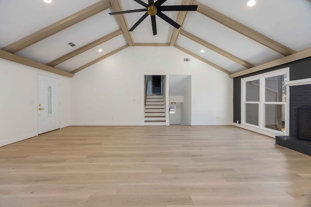 unfurnished living room with a fireplace, visible vents, a ceiling fan, light wood-style floors, and beam ceiling