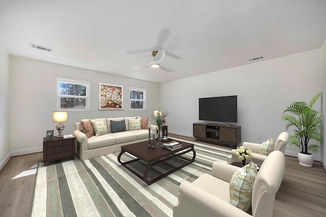 living room with baseboards, visible vents, and light wood-style floors