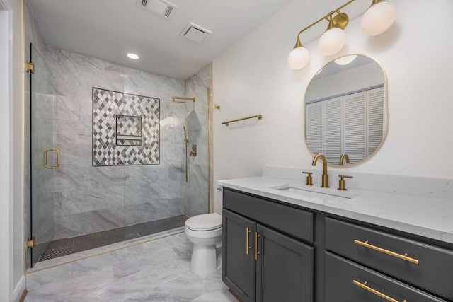 bathroom featuring toilet, vanity, visible vents, marble finish floor, and a stall shower