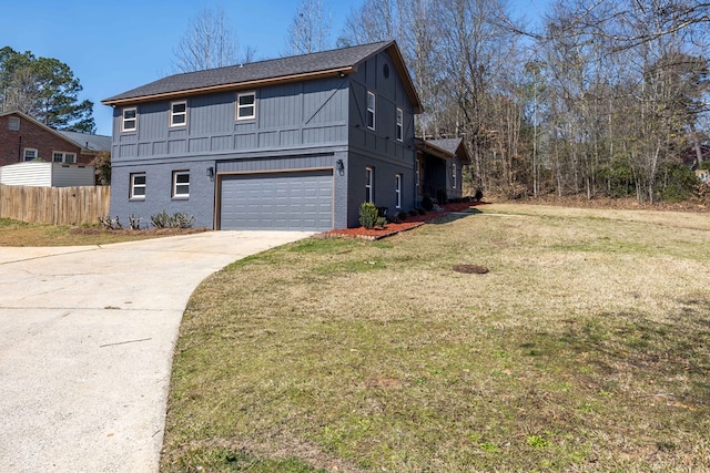 view of front of property with an attached garage, brick siding, fence, driveway, and a front lawn