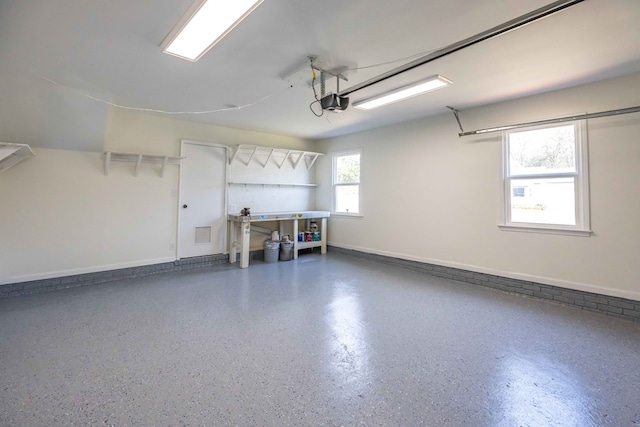 garage with baseboards and a garage door opener