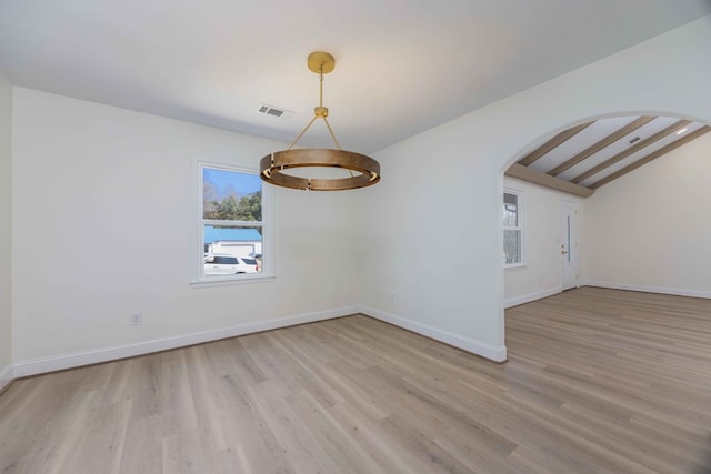 unfurnished room with vaulted ceiling with beams, light wood-style floors, visible vents, and arched walkways