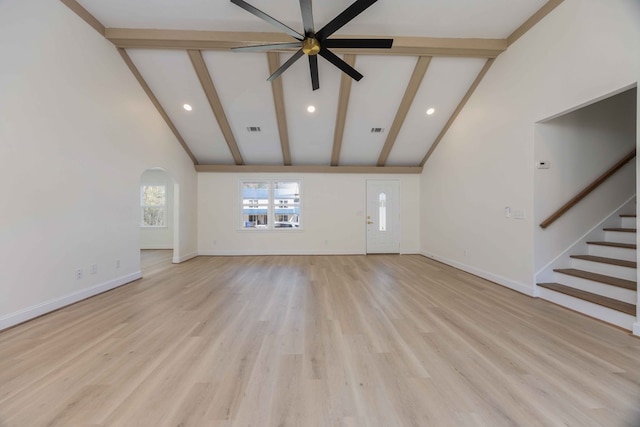 unfurnished living room with light wood-style floors, baseboards, stairway, and beam ceiling