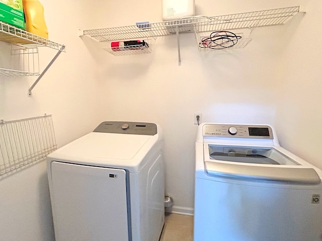 clothes washing area with washer and clothes dryer