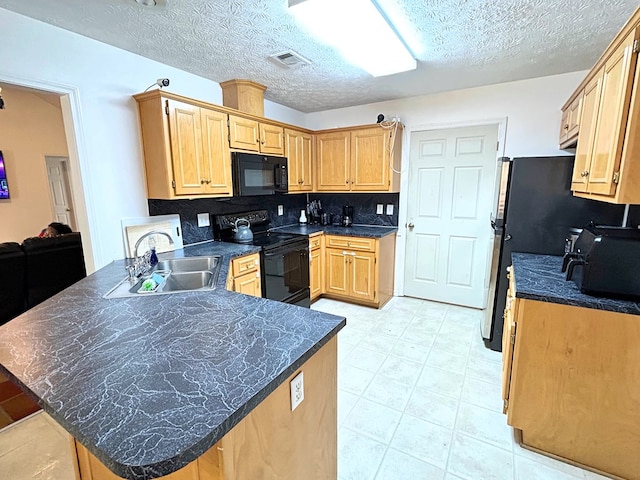 kitchen featuring black appliances, sink, decorative backsplash, a textured ceiling, and kitchen peninsula