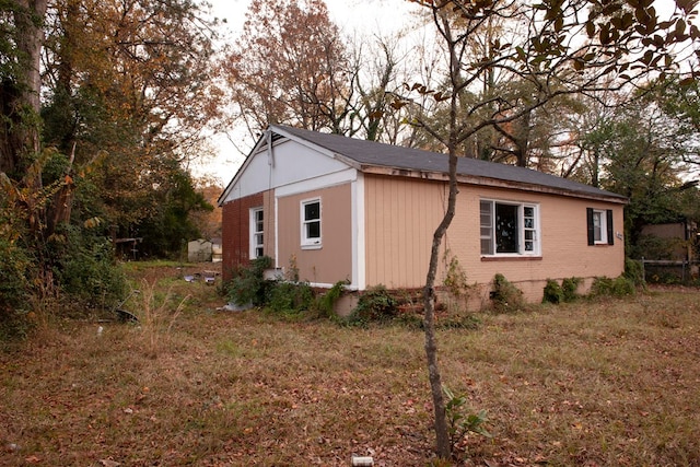 view of property exterior featuring a lawn