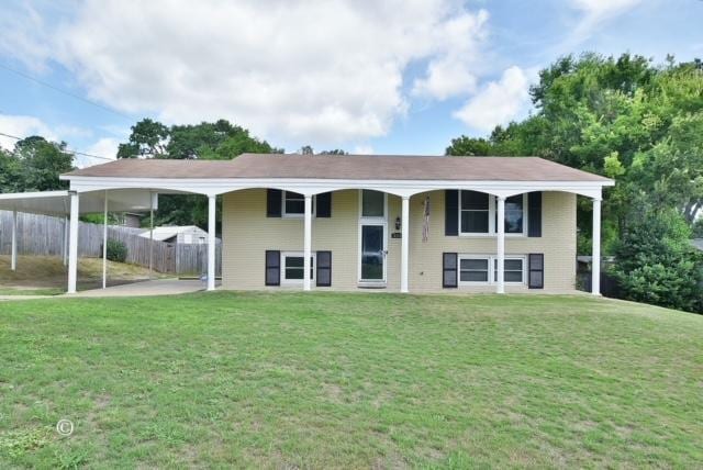 bi-level home with a carport and a front lawn