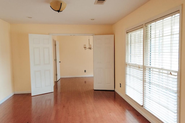 spare room with hardwood / wood-style flooring