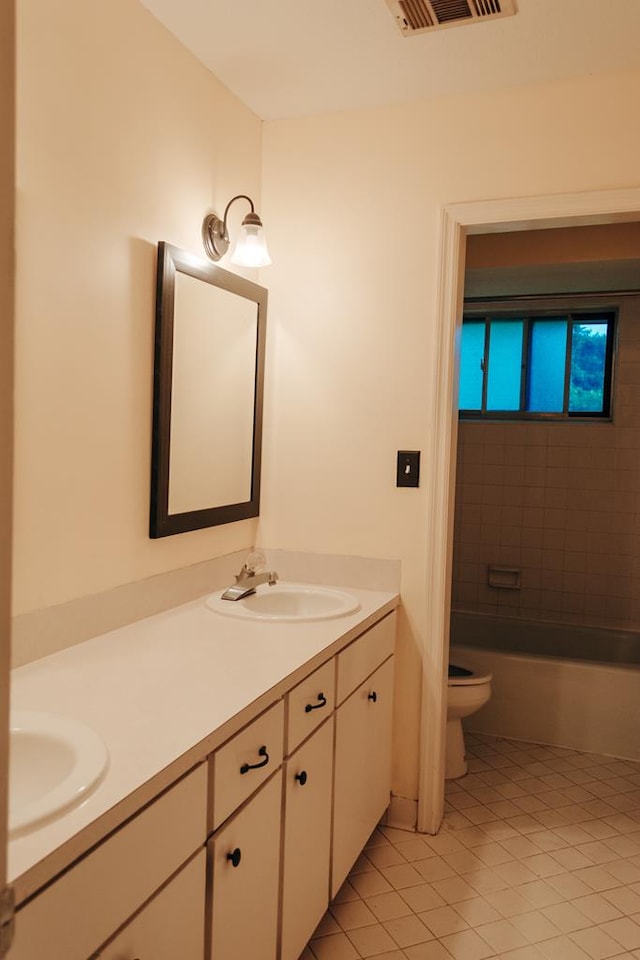 bathroom featuring tile patterned flooring, vanity, and toilet