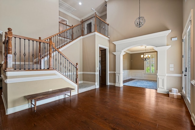 8026 Splendor Way, Columbus, GA 31904 - foyer entrance featuring a chandelier, decorative columns, a high ceiling, arched walkways, and hardwood / wood-style flooring
