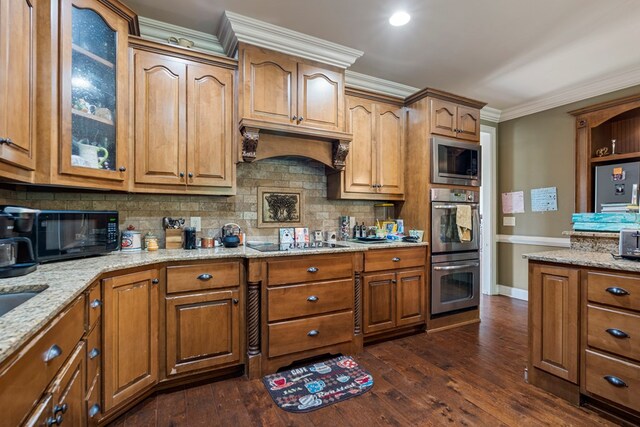 8026 Splendor Way, Columbus, GA 31904 - kitchen featuring black appliances, backsplash, light stone countertops, glass insert cabinets, and dark wood-style floors