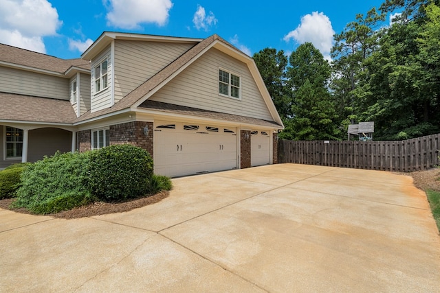 8026 Splendor Way, Columbus, GA 31904 - view of home's exterior with brick siding, concrete driveway, a garage, and roof with shingles