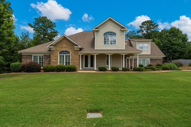 8026 Splendor Way, Columbus, GA 31904 - traditional home featuring french doors, a front yard, a shingled roof, brick siding, and stone siding
