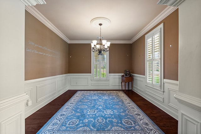 8026 Splendor Way, Columbus, GA 31904 - unfurnished dining area featuring healthy amount of natural light, a chandelier, ornamental molding, dark wood finished floors, and wainscoting