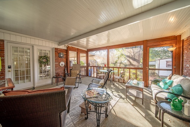 sunroom / solarium featuring a wealth of natural light and beamed ceiling