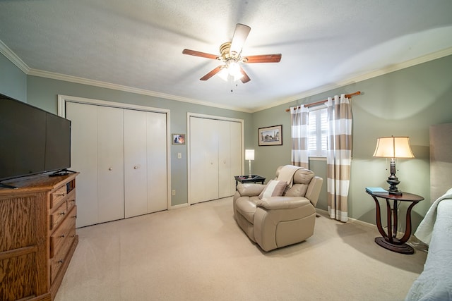 sitting room with ornamental molding, light carpet, ceiling fan, and a textured ceiling