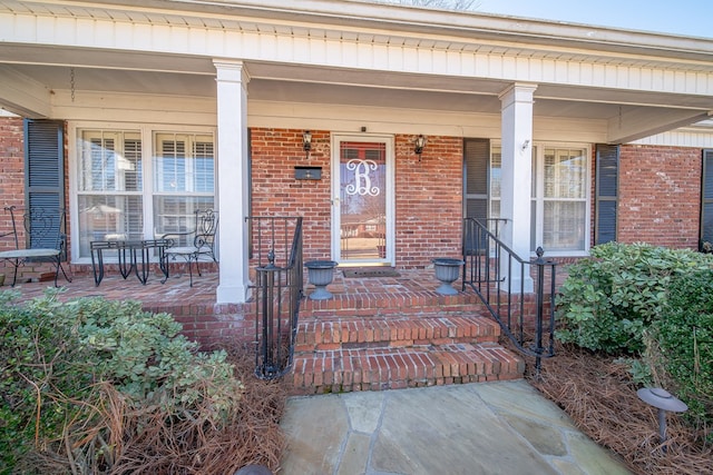 view of exterior entry with covered porch