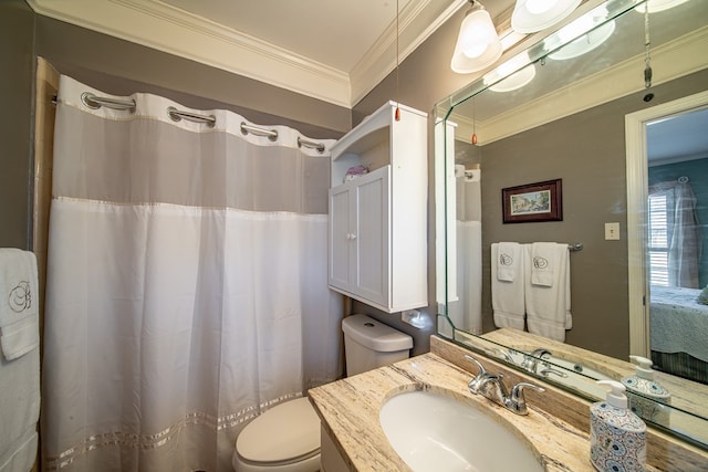 bathroom with crown molding, vanity, and toilet