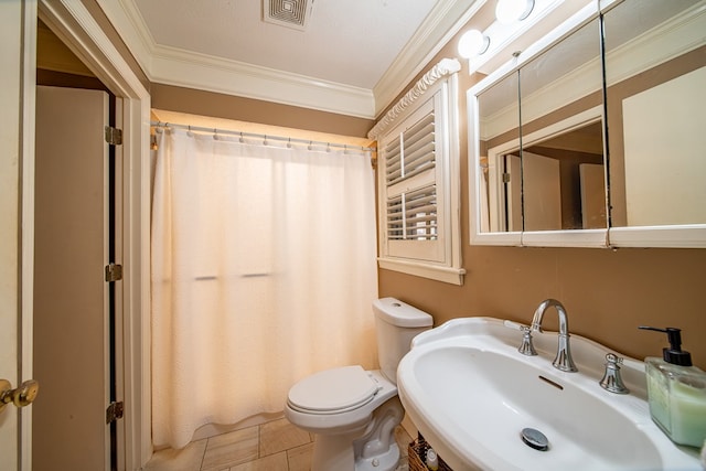 bathroom with sink, ornamental molding, and toilet