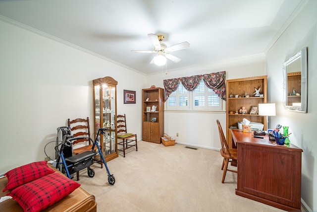 carpeted home office with crown molding and ceiling fan