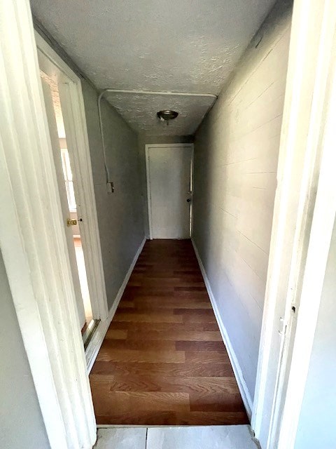 corridor with dark hardwood / wood-style floors