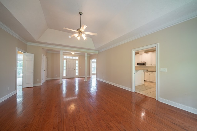4548 Carnoustie Ln, Columbus, GA 31909 - unfurnished room with a raised ceiling, a ceiling fan, light wood-style flooring, crown molding, and ornate columns