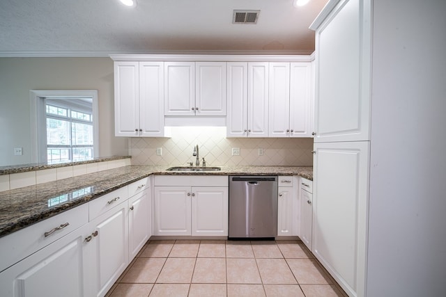 4548 Carnoustie Ln, Columbus, GA 31909 - kitchen with stainless steel dishwasher, tasteful backsplash, light tile patterned floors, white cabinetry, and recessed lighting