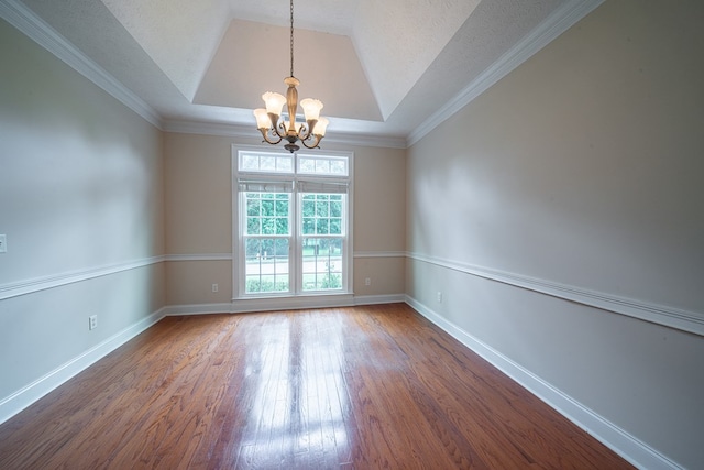 4548 Carnoustie Ln, Columbus, GA 31909 - spare room with a chandelier, wood finished floors, a raised ceiling, and crown molding