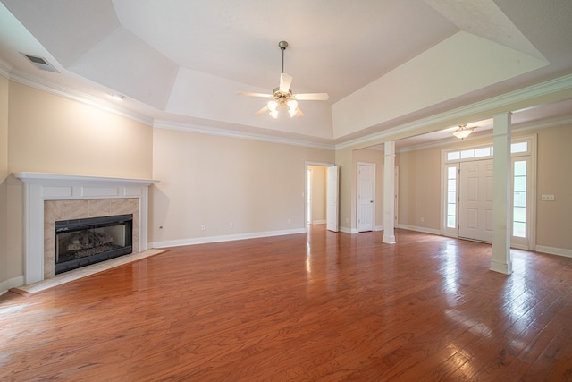 4548 Carnoustie Ln, Columbus, GA 31909 - unfurnished living room featuring ornate columns, a ceiling fan, a tray ceiling, wood finished floors, and crown molding
