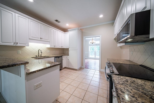 4548 Carnoustie Ln, Columbus, GA 31909 - kitchen with appliances with stainless steel finishes, dark stone counters, a peninsula, white cabinetry, and crown molding