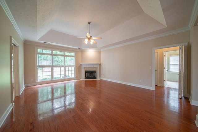 4548 Carnoustie Ln, Columbus, GA 31909 - unfurnished living room with a tray ceiling, ceiling fan, wood finished floors, a high end fireplace, and ornamental molding