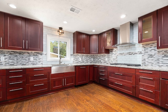 3409 Primrose Rd, Columbus, GA 31907 - kitchen with wall chimney range hood, dark brown cabinets, dark wood-type flooring, a textured ceiling, and decorative backsplash