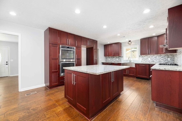 3409 Primrose Rd, Columbus, GA 31907 - kitchen featuring dark brown cabinets, appliances with stainless steel finishes, tasteful backsplash, recessed lighting, and light stone countertops