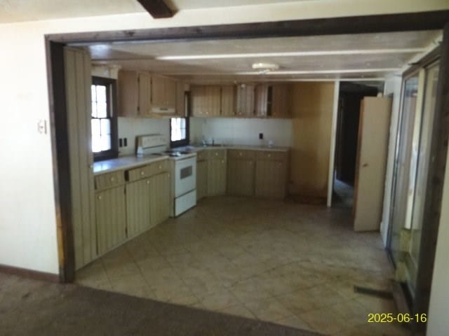 66 Glennhaven Rd, Phenix City, AL 36869 - kitchen with white range with electric stovetop, light countertops, and exhaust hood