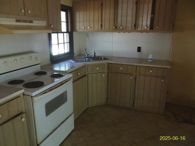 66 Glennhaven Rd, Phenix City, AL 36869 - kitchen with electric range, under cabinet range hood, tile countertops, and dark tile patterned floors
