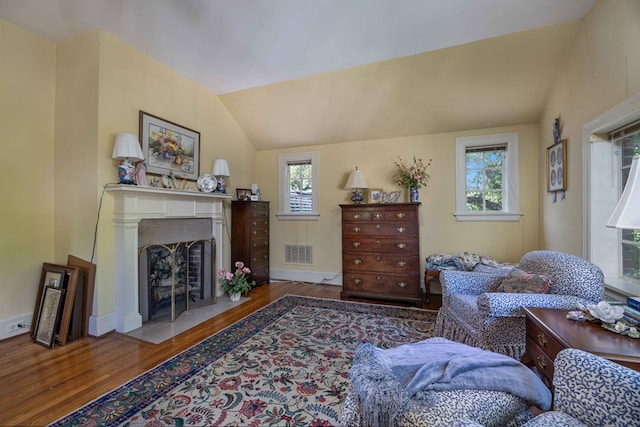 1400 Eberhart Ave, Columbus, GA 31906 - living room with wood finished floors, plenty of natural light, lofted ceiling, a fireplace with flush hearth, and baseboards