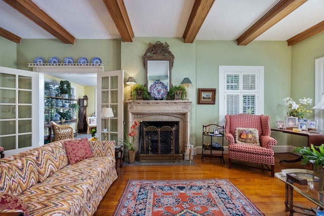 1400 Eberhart Ave, Columbus, GA 31906 - living room featuring wood finished floors, beamed ceiling, and a fireplace with flush hearth