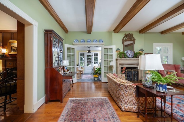 1400 Eberhart Ave, Columbus, GA 31906 - living area featuring wood finished floors, a fireplace, beamed ceiling, ceiling fan, and french doors