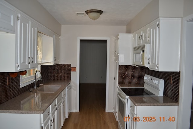 13642 Macon Rd, Upatoi, GA 31829 - kitchen featuring white appliances, white cabinets, wood finished floors, and tasteful backsplash