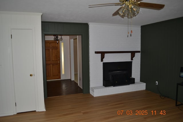 13642 Macon Rd, Upatoi, GA 31829 - unfurnished living room with a ceiling fan, wood finished floors, crown molding, and a chandelier